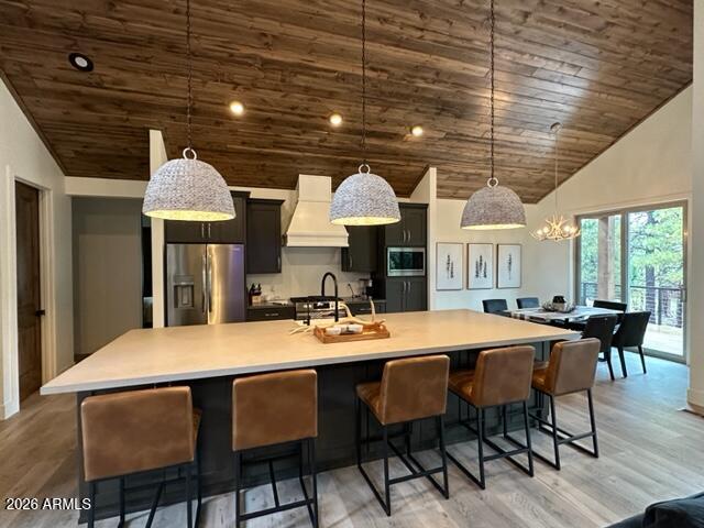 4260 West Falling Leaf Road Show Low, AZ 85901 - Photo 5 of 32 a dining room with stainless steel appliances granite countertop a table chairs and a chandelier