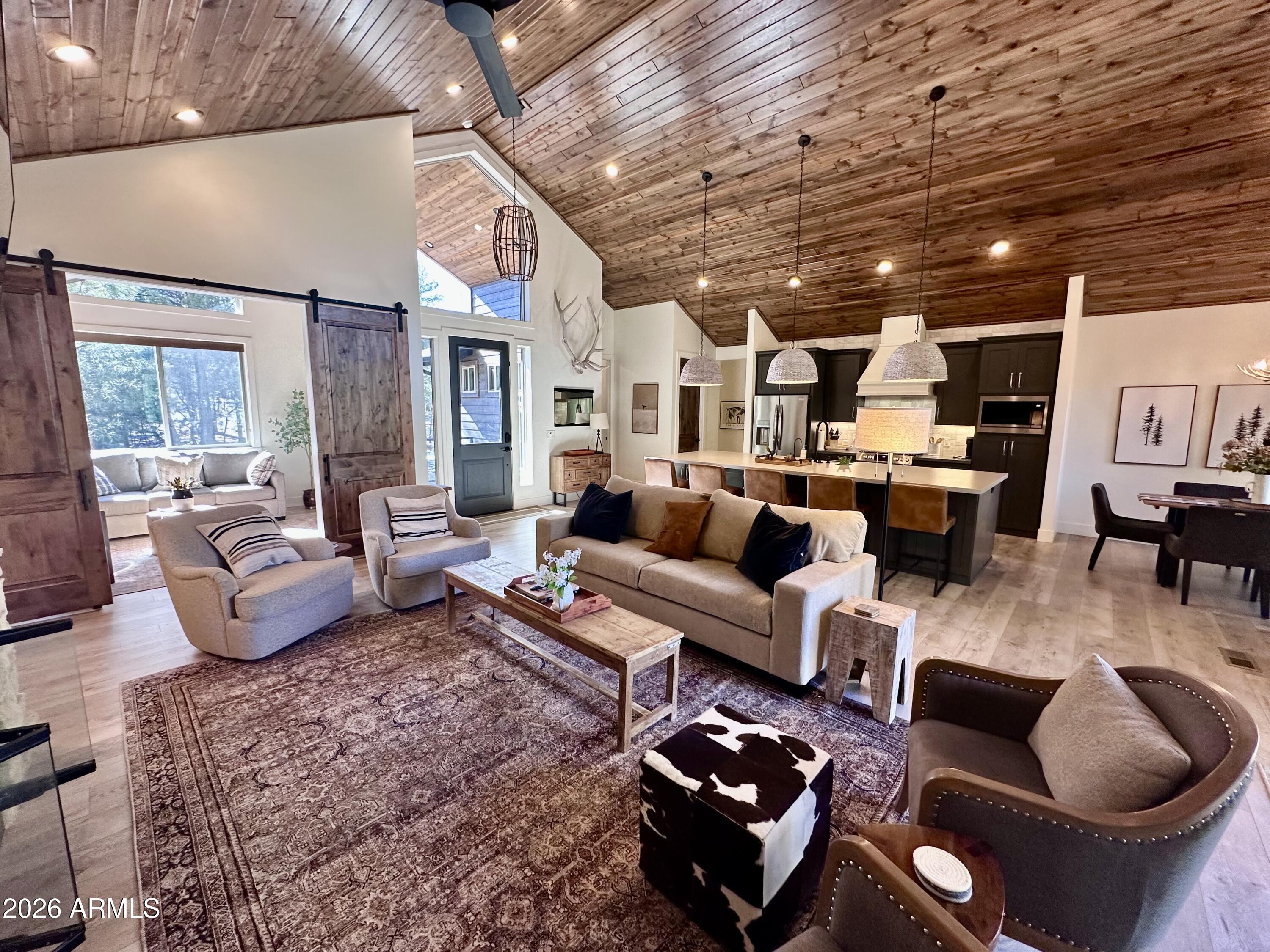 4260 West Falling Leaf Road Show Low, AZ 85901 - Photo 8 of 32 a living room with furniture and a chandelier