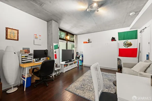a view of a workspace with furniture and a window