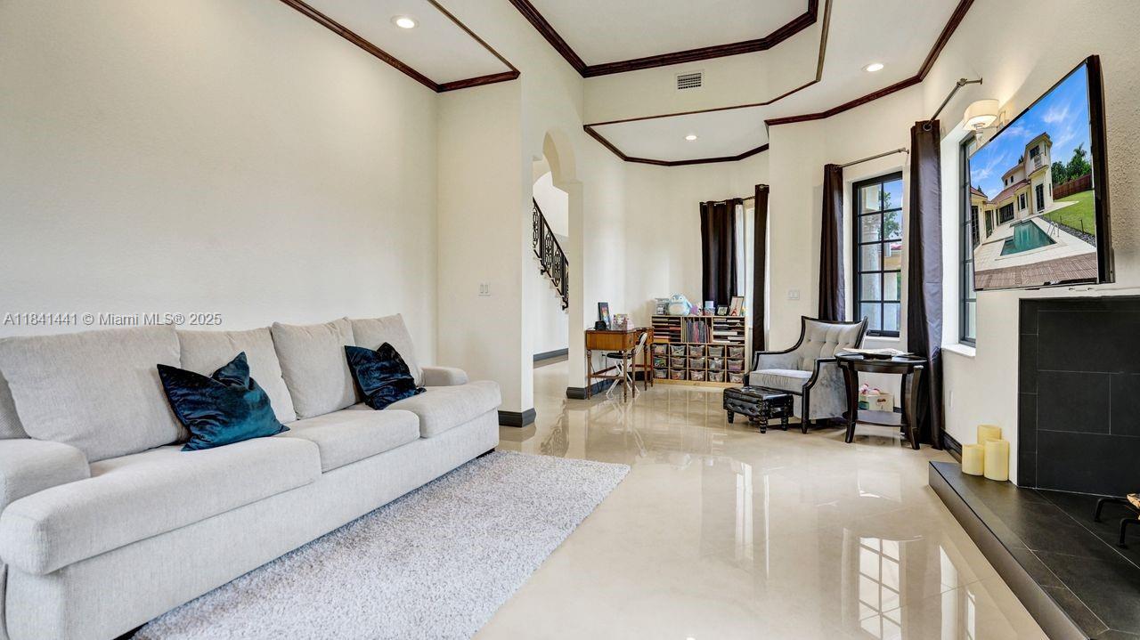 3311 Southwest 118th Terrace Davie, FL 33330 - Photo 27 of 95 a living room with furniture a flat screen tv and a large window