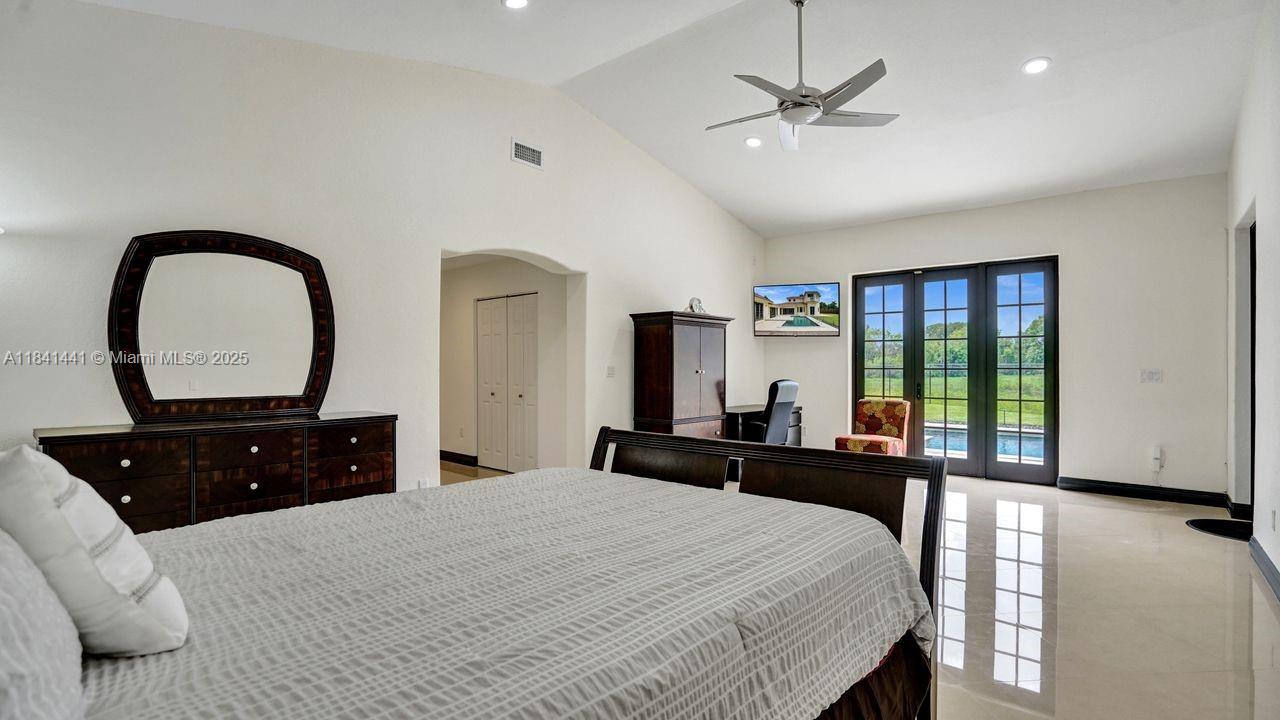 3311 Southwest 118th Terrace Davie, FL 33330 - Photo 46 of 95 a bedroom with a large bed and a large window