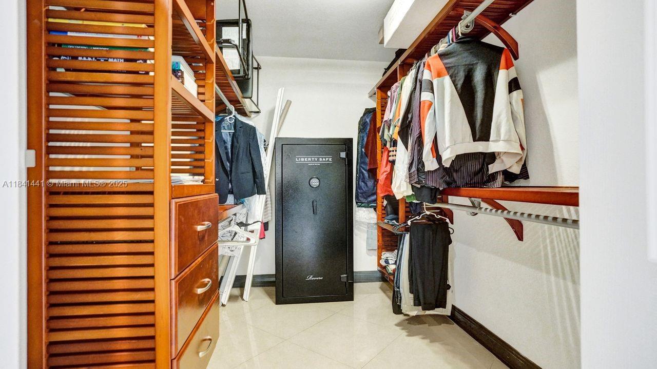 3311 Southwest 118th Terrace Davie, FL 33330 - Photo 50 of 95 a view of walk in closet with clothes and shoes