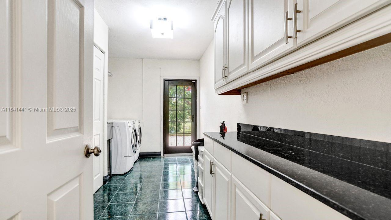 3311 Southwest 118th Terrace Davie, FL 33330 - Photo 56 of 95 a kitchen with a refrigerator and a stove