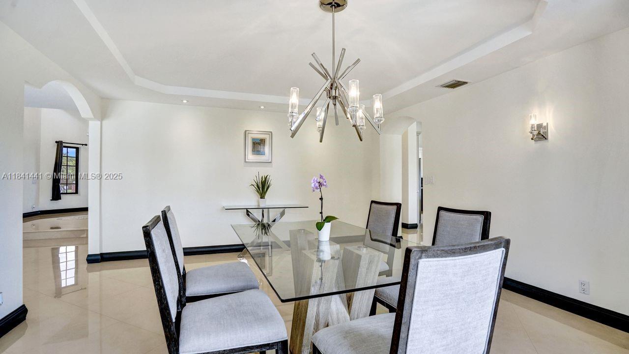 3311 Southwest 118th Terrace Davie, FL 33330 - Photo 58 of 95 a view of a dining room with furniture and wooden floor