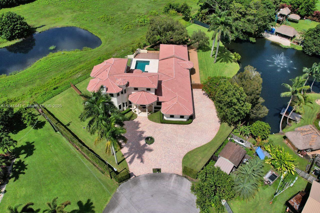 3311 Southwest 118th Terrace Davie, FL 33330 - Photo 88 of 95 an aerial view of a house with a garden and lake view