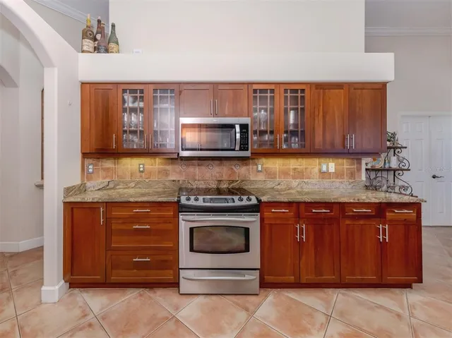 a kitchen with stainless steel appliances granite countertop a stove and a microwave