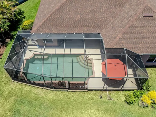 a view of swimming pool with seating space and ocean view