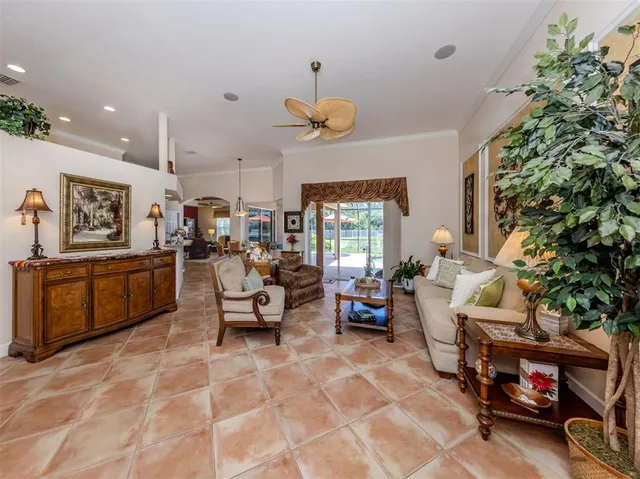 a living room with furniture a chandelier and a window