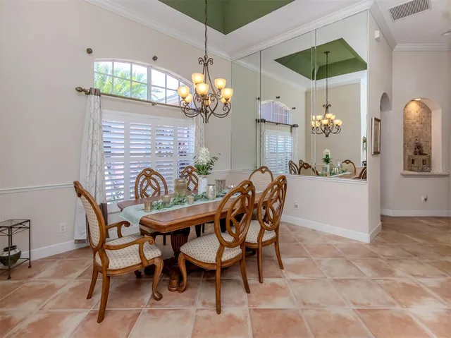 a view of a dining room with furniture and chandelier