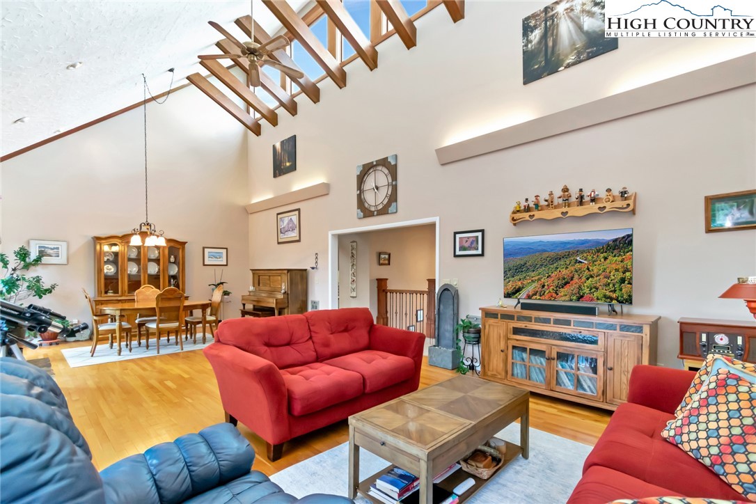 a living room with furniture a ceiling fan and a rug