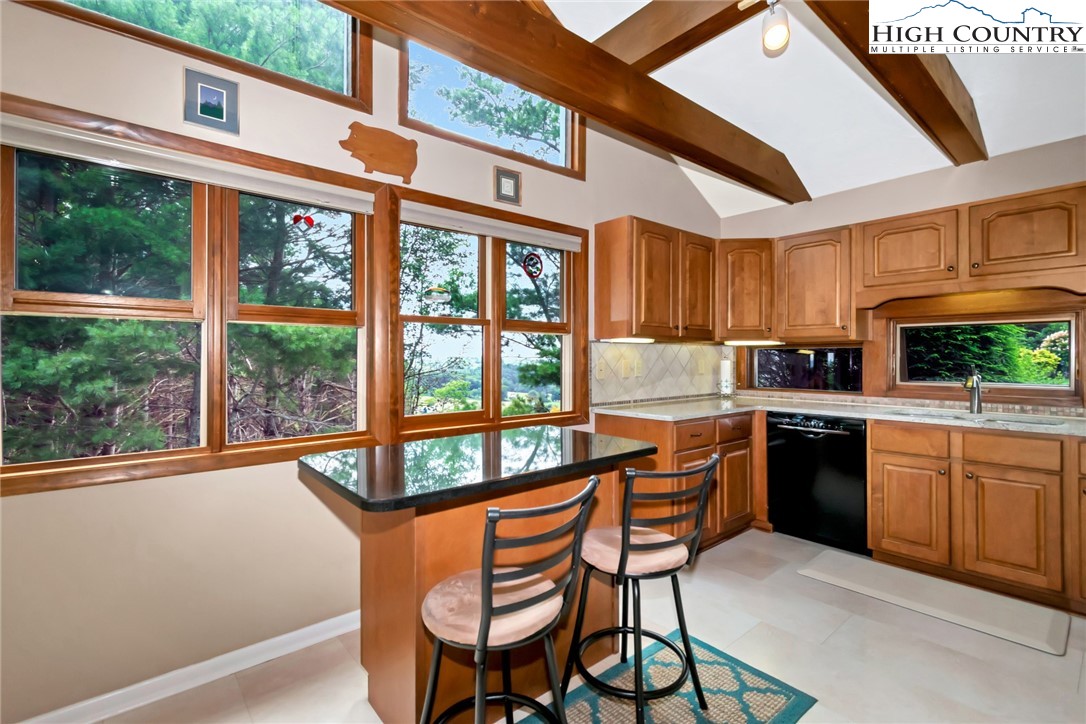 314 Heather Street Boone, NC 28607 - Photo 15 of 50 a kitchen with stainless steel appliances granite countertop a stove a refrigerator a sink and a dining table and chairs