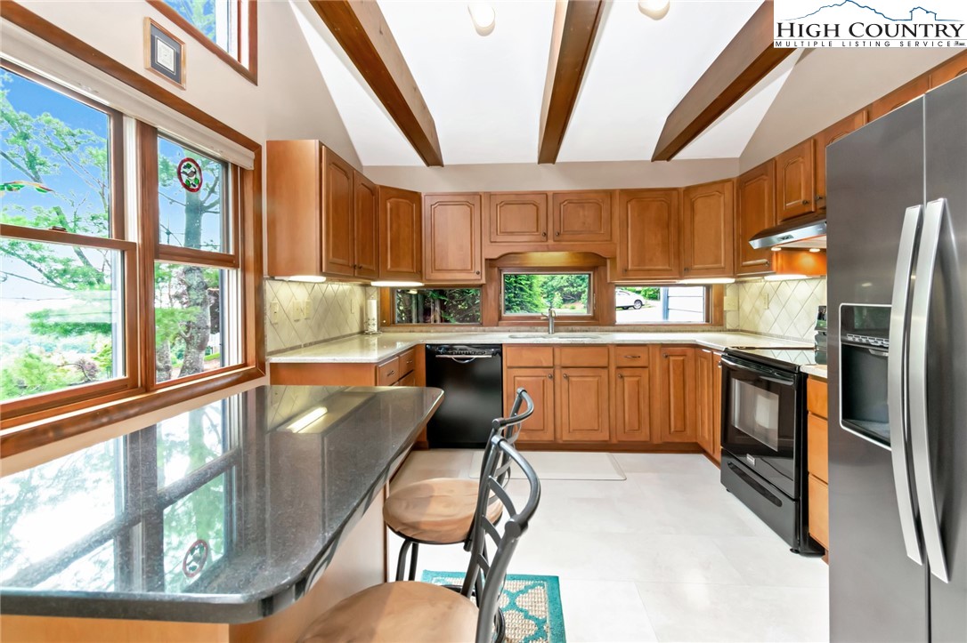 314 Heather Street Boone, NC 28607 - Photo 16 of 50 a kitchen with a window a sink and a refrigerator