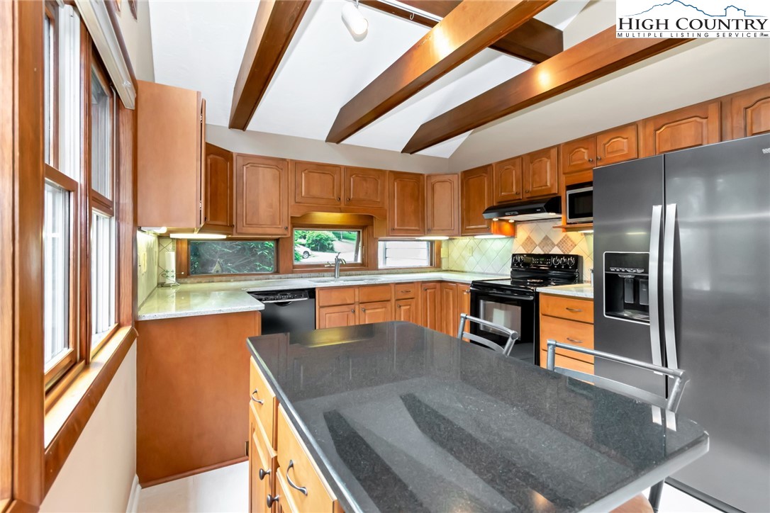 314 Heather Street Boone, NC 28607 - Photo 17 of 50 a kitchen with stainless steel appliances granite countertop a refrigerator a sink and a stove