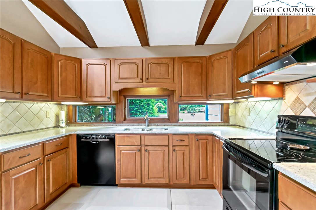314 Heather Street Boone, NC 28607 - Photo 19 of 50 a kitchen with granite countertop a stove sink and cabinets