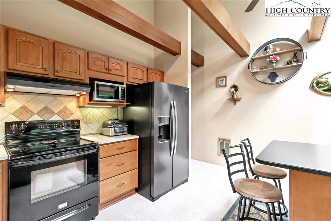 314 Heather Street Boone, NC 28607 - Photo 22 of 50 a kitchen with stainless steel appliances granite countertop a stove and a refrigerator