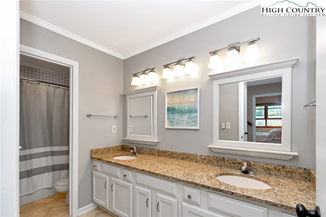 314 Heather Street Boone, NC 28607 - Photo 31 of 50 a bathroom with a granite countertop sink and a mirror