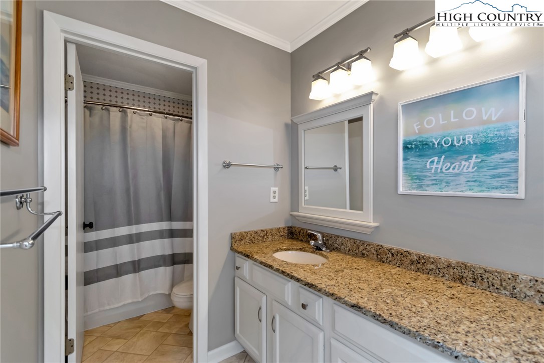 314 Heather Street Boone, NC 28607 - Photo 32 of 50 a bathroom with a granite countertop sink and a mirror
