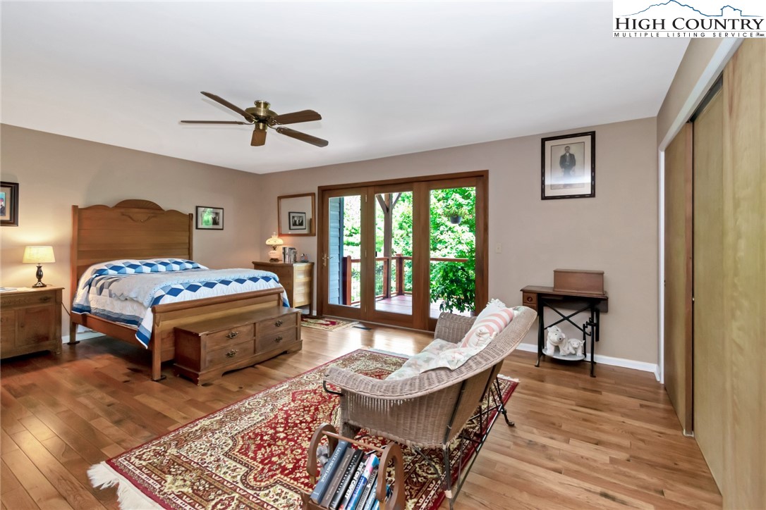 314 Heather Street Boone, NC 28607 - Photo 33 of 50 a bedroom with a bed a large window and wooden floor
