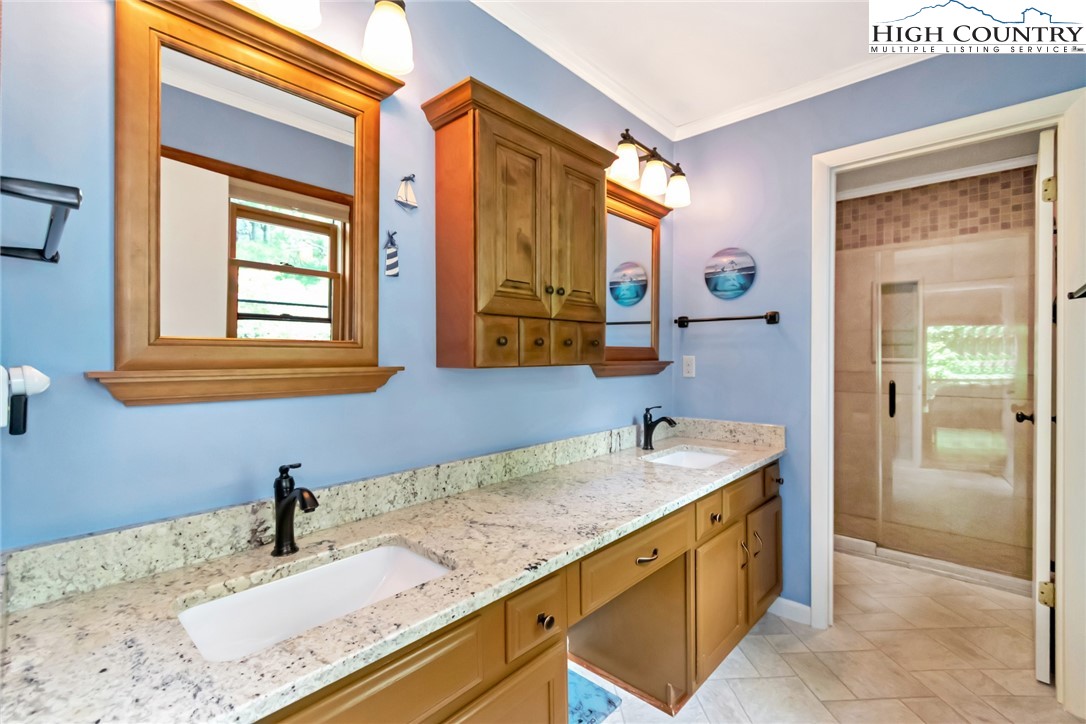 314 Heather Street Boone, NC 28607 - Photo 36 of 50 a bathroom with a granite countertop sink and a mirror