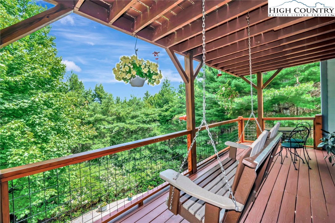 314 Heather Street Boone, NC 28607 - Photo 44 of 50 a view of a balcony with wooden floor and outdoor seating