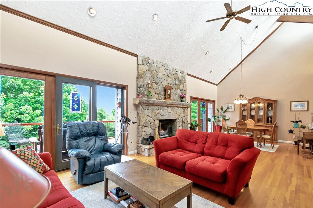 314 Heather Street Boone, NC 28607 - Photo 7 of 50 a living room with furniture a fireplace and a floor to ceiling window