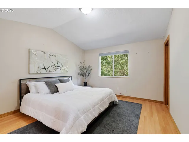 a bedroom with a large bed and a window