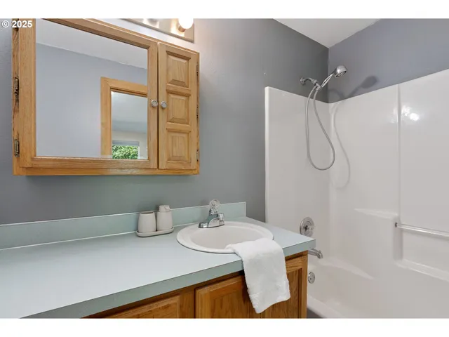 a bathroom with a sink vanity granite and a mirror