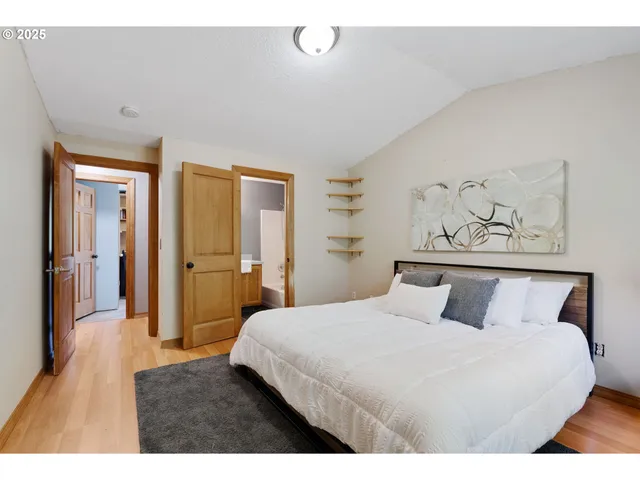 a bedroom with a large bed and a chandelier