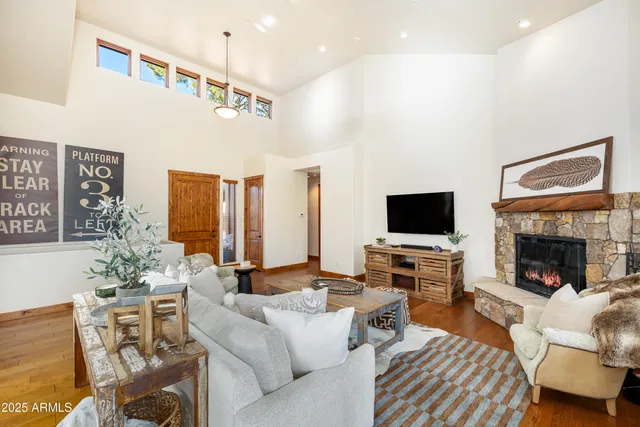 a kitchen with a table chairs stove and wooden floor