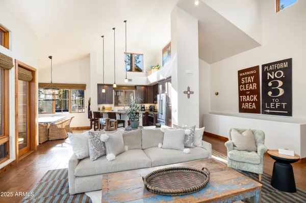 a view of a dining room with furniture wooden floor and a chandelier