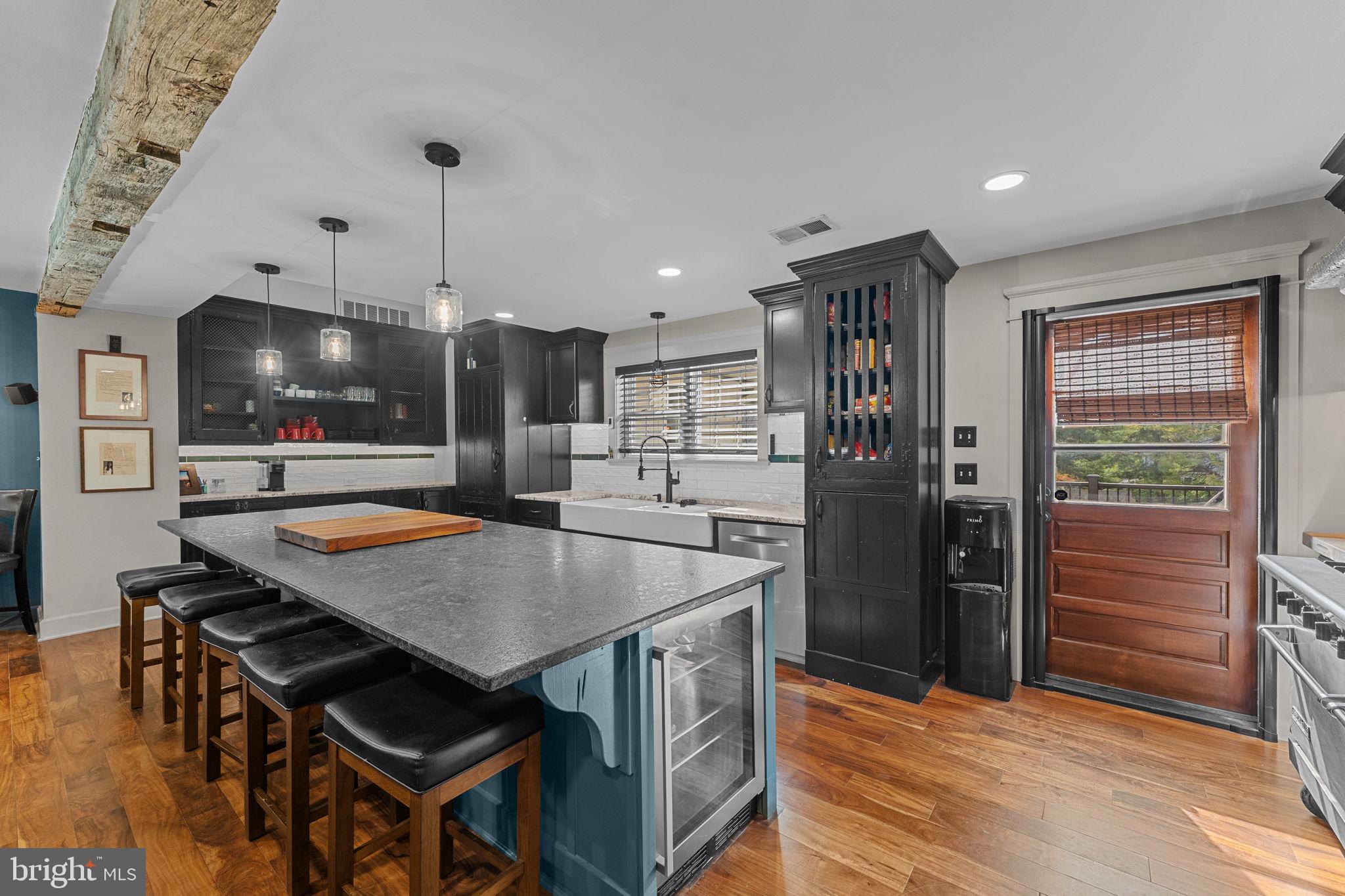 10 Arlington Road Malvern, PA 19355 - Photo 16 of 38 a kitchen with stainless steel appliances a kitchen island a stove and a refrigerator