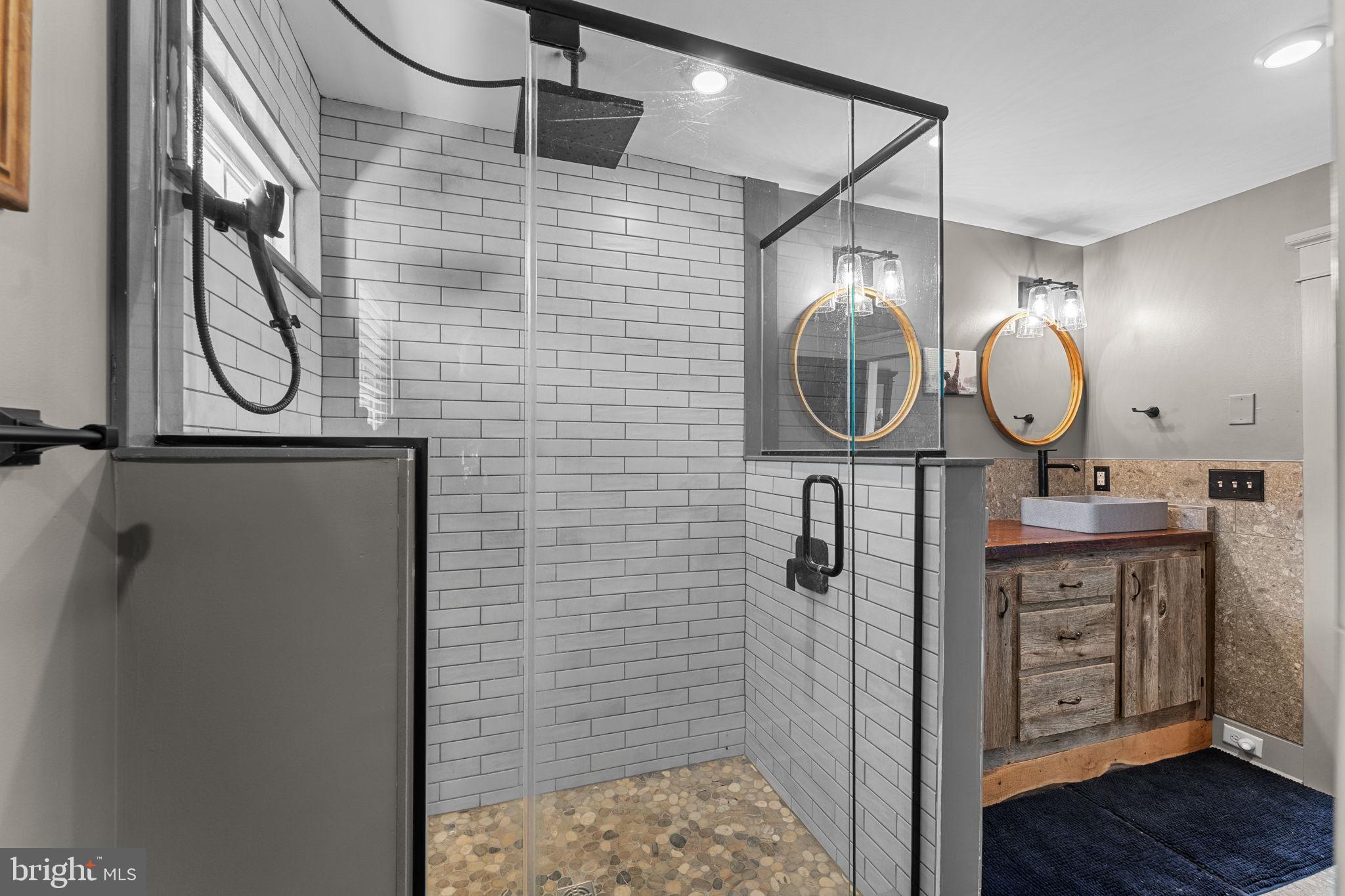 10 Arlington Road Malvern, PA 19355 - Photo 25 of 38 a bathroom with a mirror and a shower