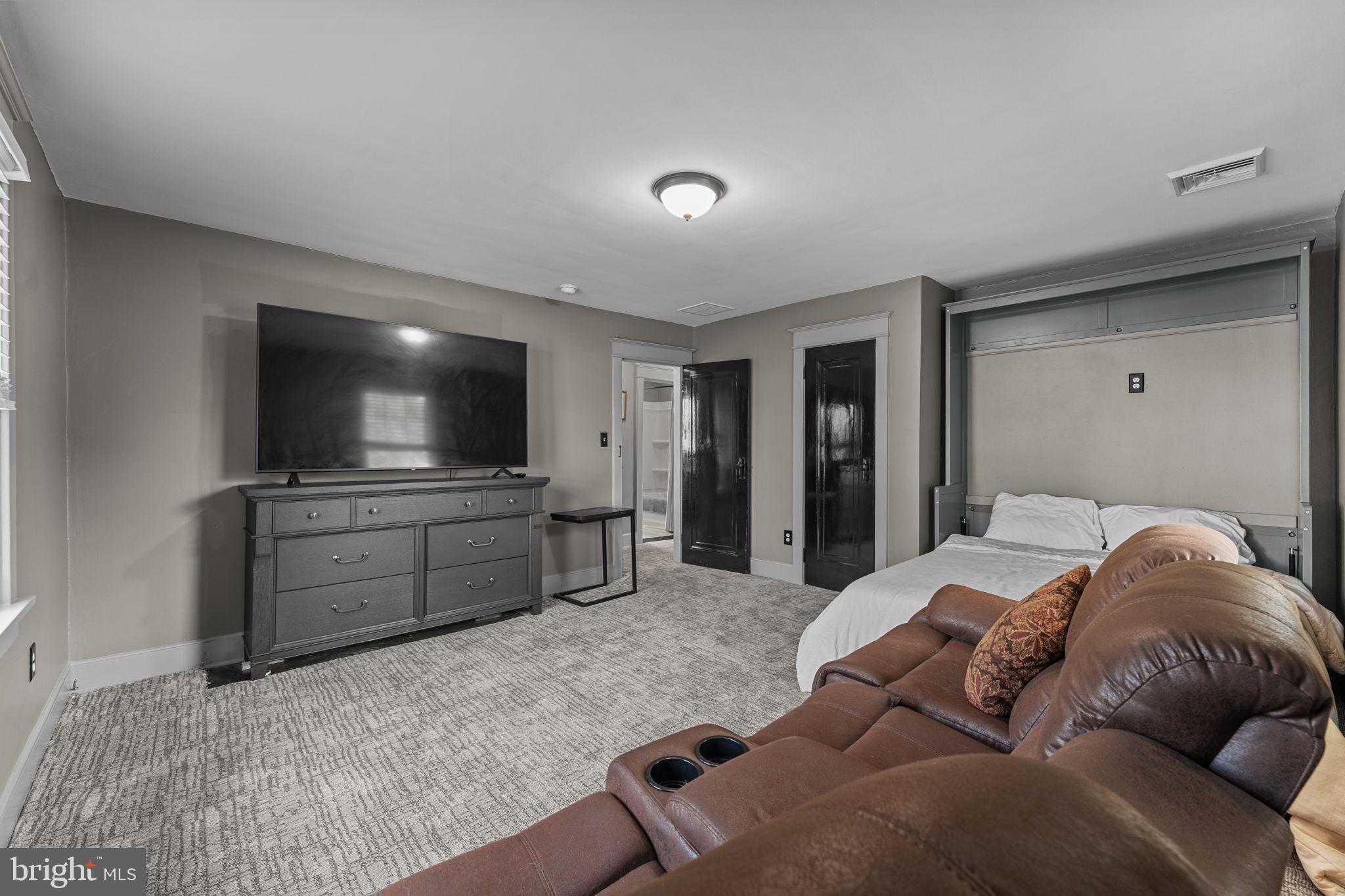 10 Arlington Road Malvern, PA 19355 - Photo 29 of 38 a living room with furniture and a flat screen tv