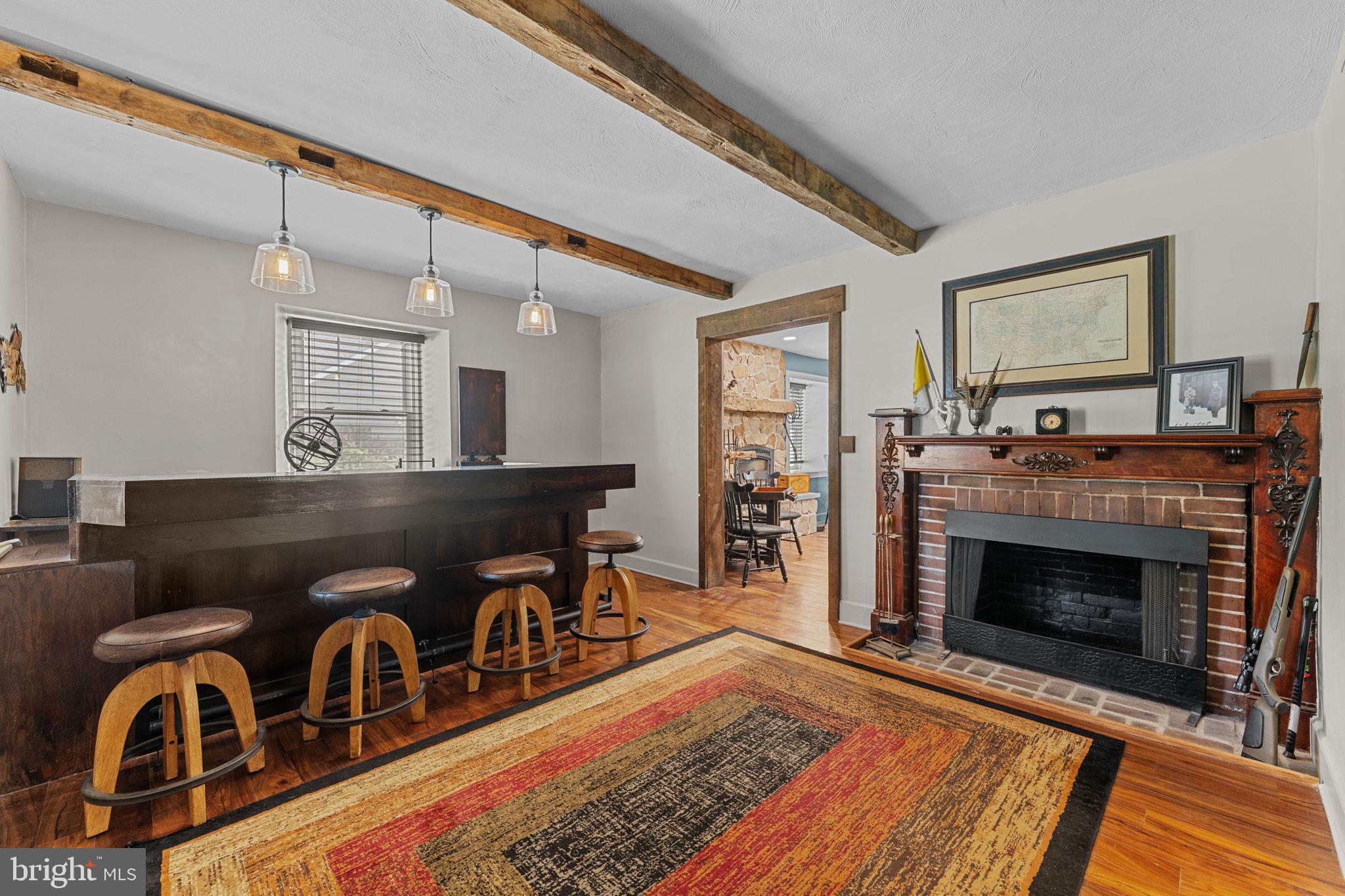 10 Arlington Road Malvern, PA 19355 - Photo 6 of 38 a living room with furniture and a fireplace