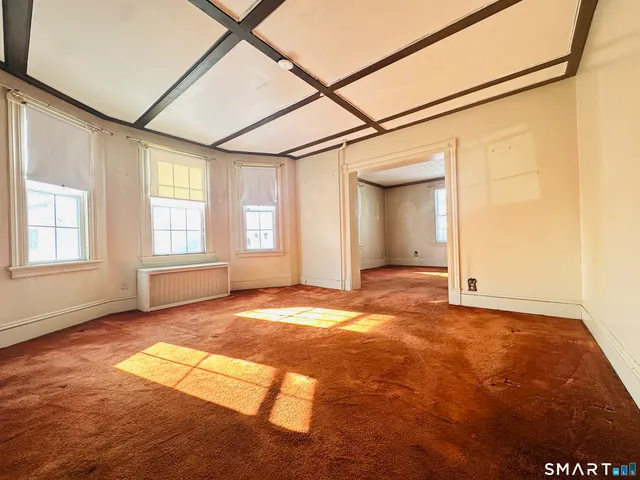 an empty room with windows and entrance