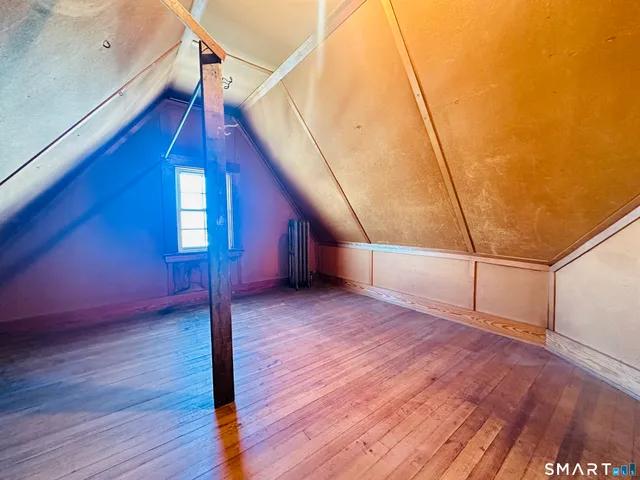 a view of a room with wooden floor and stairs