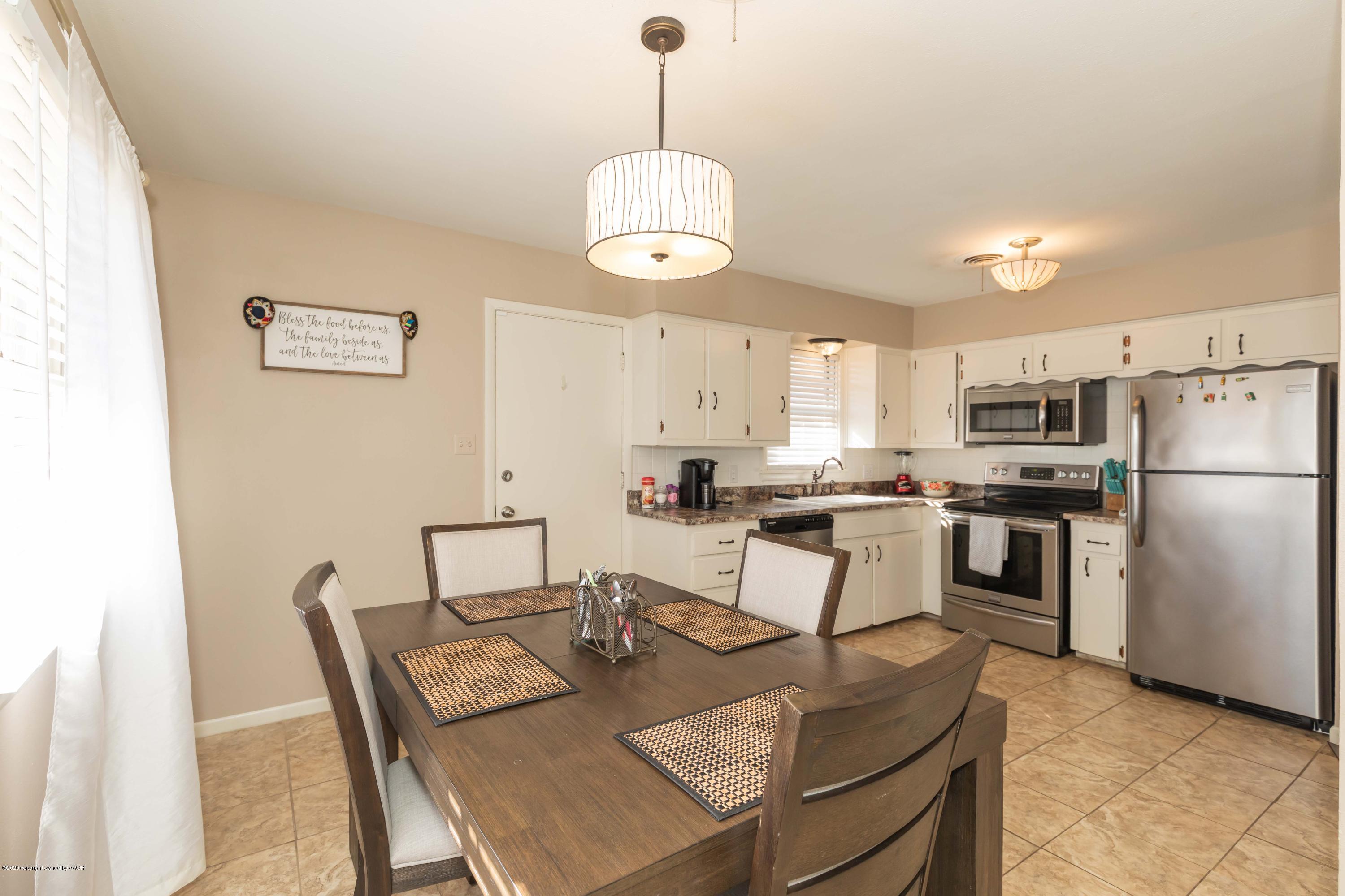 4712 South Bryan Street Amarillo, TX 79110 - Photo 11 of 36 a view of kitchen with sink dining table and chairs