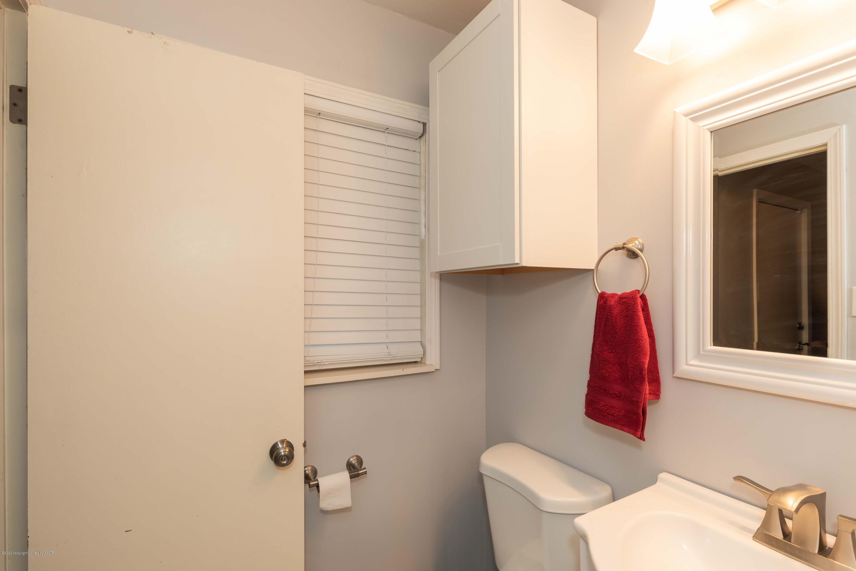 4712 South Bryan Street Amarillo, TX 79110 - Photo 23 of 36 a bathroom with a toilet and a window