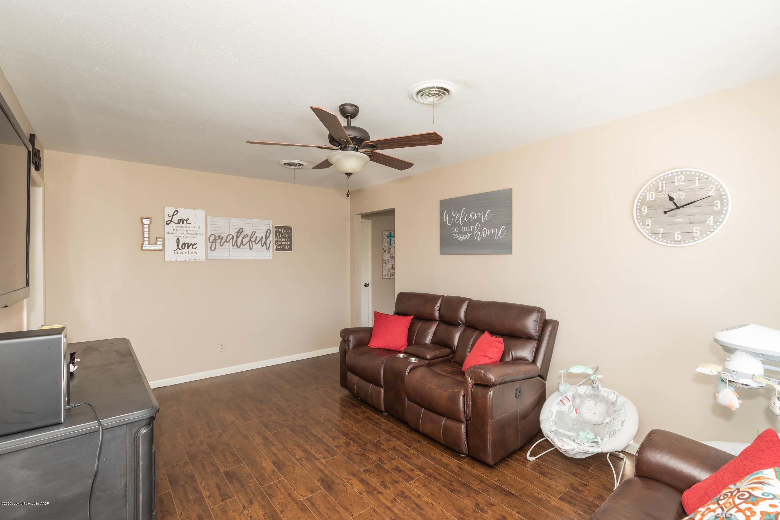 4712 South Bryan Street Amarillo, TX 79110 - Photo 6 of 36 a living room with furniture and a wooden floor