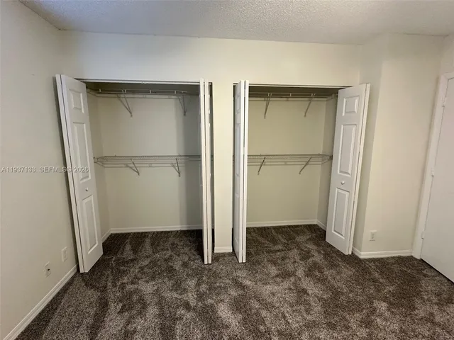 a utility room with cabinets washer and dryer