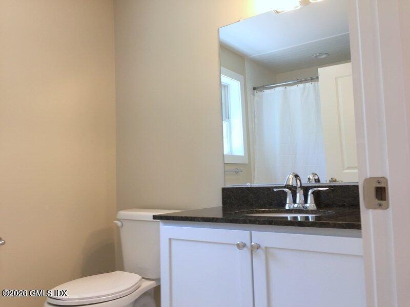 180 Hamilton Avenue, Unit C Greenwich, CT 06830 - Photo 13 of 15 a bathroom with a sink a toilet and vanity