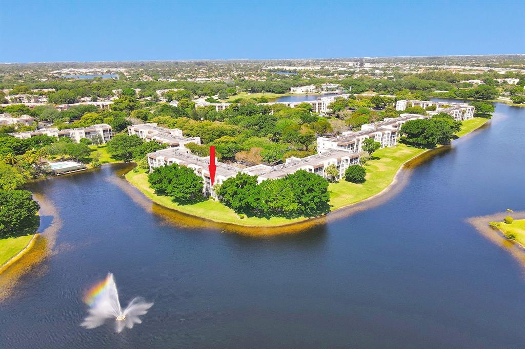 an aerial view of residential houses with outdoor space and swimming pool