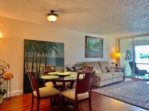 a living room with furniture two lamps and a wooden floor