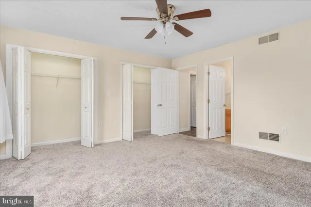 a bathroom with a granite countertop toilet sink and a mirror