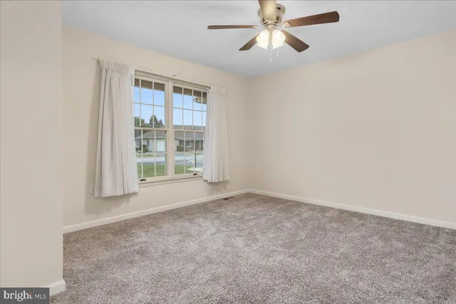 an empty room with a empty space and windows