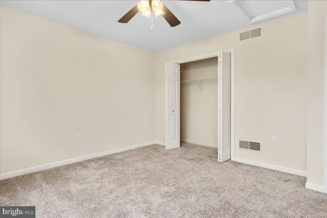a bathroom with a granite countertop sink toilet a shower and a mirror
