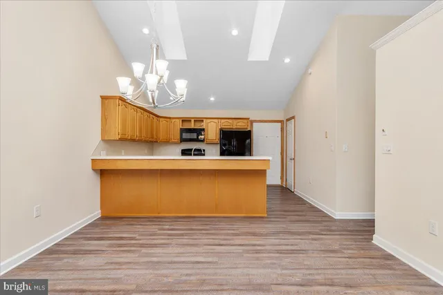 a view of kitchen with microwave and refrigerator