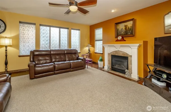 a living room with furniture a flat screen tv and a fireplace