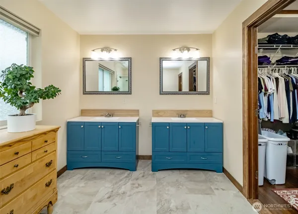 a bathroom with a granite countertop sink mirror and a bathtub