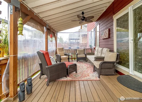 a view of a porch with furniture and garden
